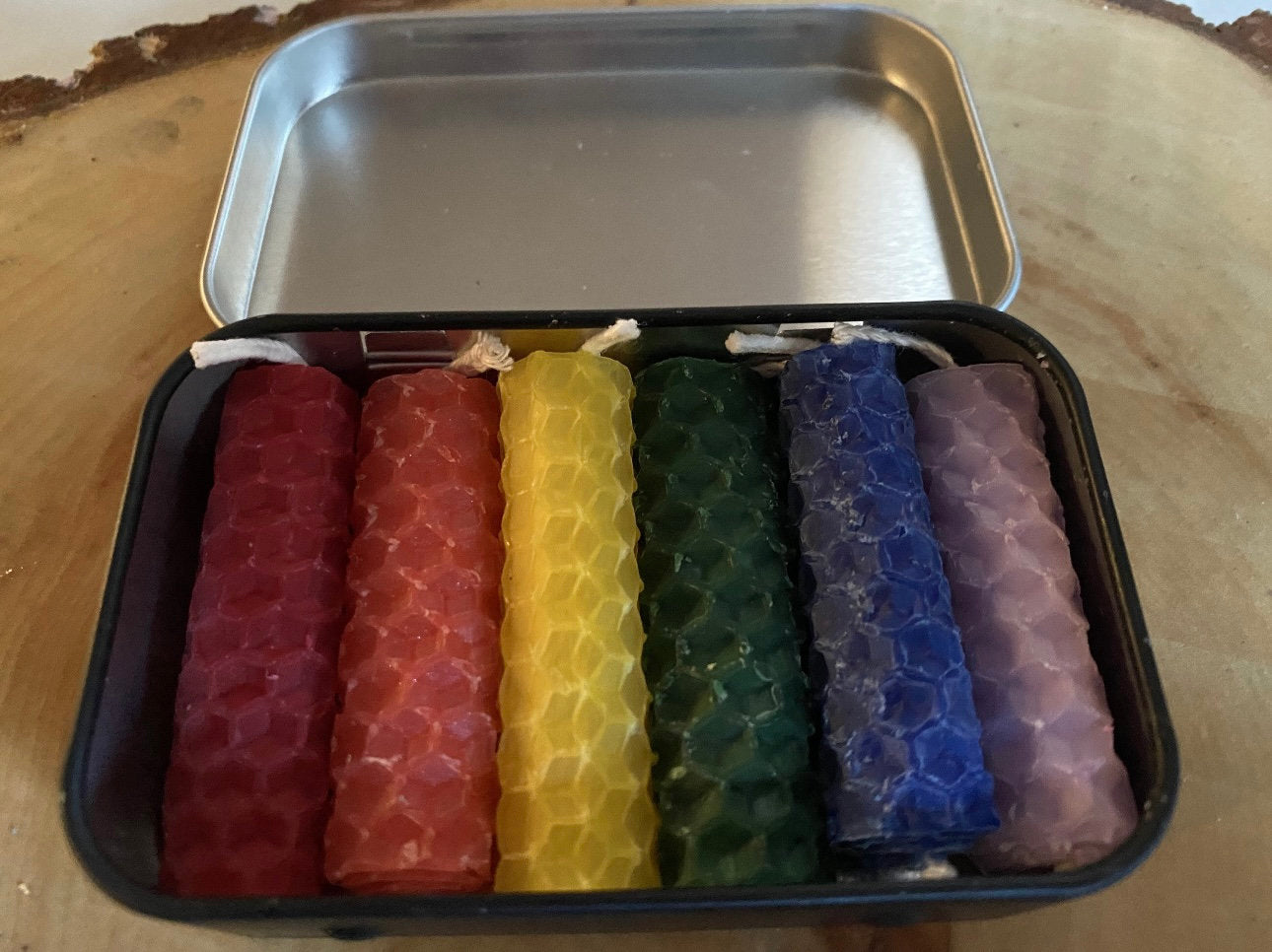 6 spell chime candles in a tin red orange yellow green blue purple